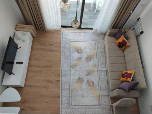 an overhead view of a living room with a couch at Retreat, block B1, unit 11 in Küçükerenköy