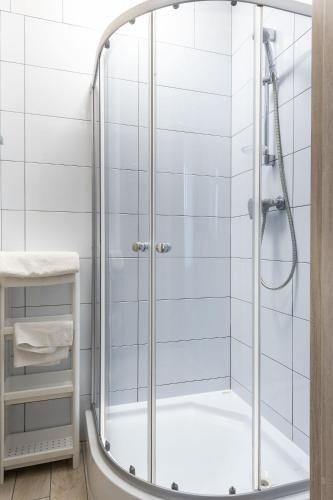 a shower with a glass door in a bathroom at Apartamenty Komfort in Częstochowa