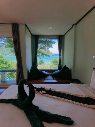 a room with two beds and a large window at Phi Phi View Point Resort in Phi Phi Don