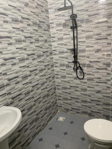 a bathroom with a shower with a toilet and a sink at Senkeur in Sali Nianiaral