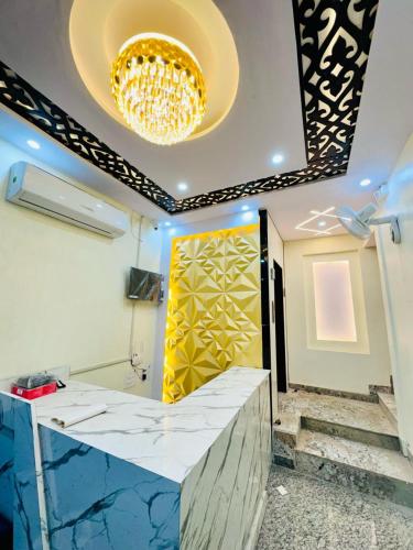 a bathroom with a chandelier and a marble counter at KashVi Hotels in Varanasi