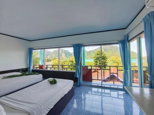 a bedroom with two beds and a large window at Phi Phi View Point Resort in Phi Phi Don