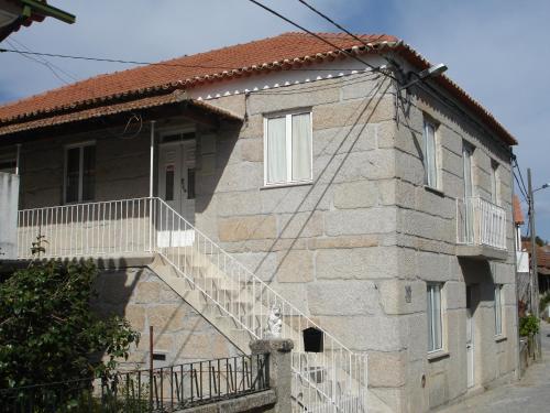 a house with a staircase on the side of it at Recanto da Avó in Seia