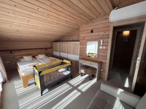 a bedroom with a bed in a wooden cabin at Apartments Pemikas I in Liptovský Mikuláš