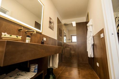 a bathroom with a shower and a sink and a mirror at Ddò Relais di Puglia in Ostuni