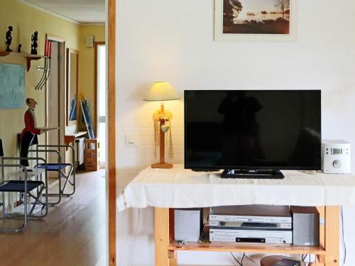 a flat screen tv on a table in a living room at 4 star holiday home in Unnaryd in Unnaryd