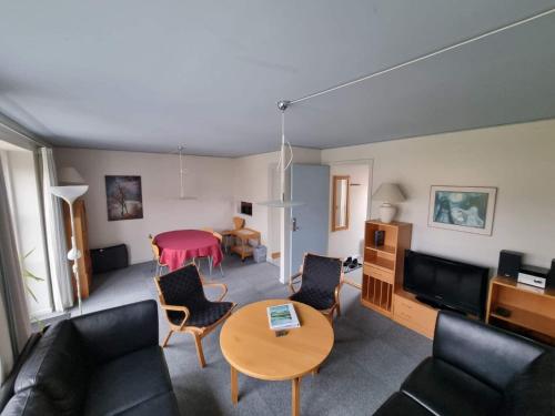 a living room with a couch and a table at 4 star holiday home in Kalvehave in Kalvehave