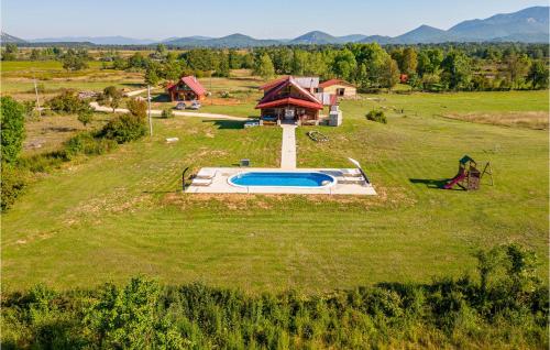an aerial view of a house with a pool in a field at Beautiful Home In Sveti Rok in Sveti Rok