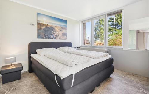 a large bed in a bedroom with two windows at Lovely Apartment In Zeulenroda-Triebes in Zadelsdorf