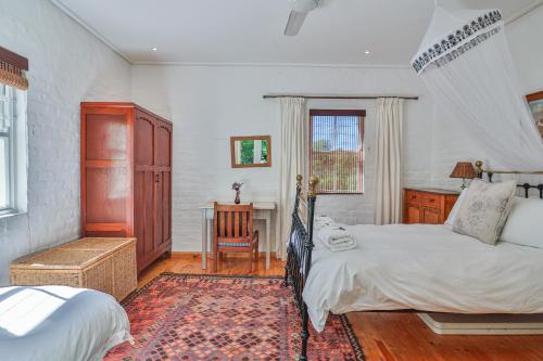a bedroom with two beds and a desk in it at Serenity in McGregor in McGregor