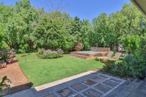 a garden with a bench and a swimming pool at Serenity in McGregor in McGregor