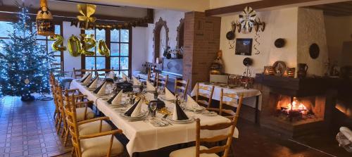 a dining room with a long table and a christmas tree at Hotel Zur Suhle in Eschbach