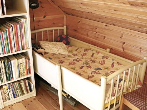 a bedroom with a bed and a book shelf at 4 star holiday home in KALV in Kalv