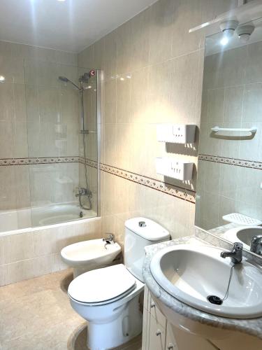 a bathroom with a toilet and a sink and a tub at Bol02 - Modern 2 bedroom apartment in Bolnuevo in Bolnuevo