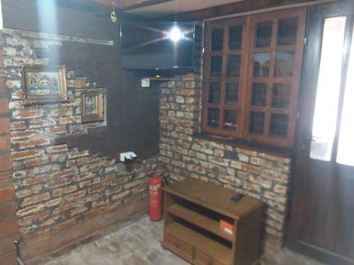 a room with a brick wall and a fire hydrant at Etno selo Smederevo PEPE- Serbia in Landol