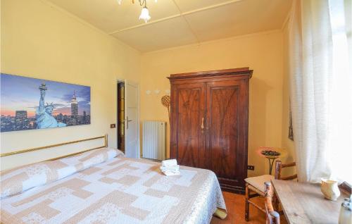 a bedroom with a bed and a wooden cabinet at Casa Le Vallette in Massarosa