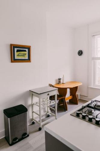 a kitchen with a stove and a table in it at Dream Beach View in Weymouth