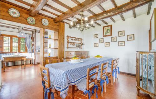 a dining room with a blue table and chairs at Villa I Cedri in Santa Lucia