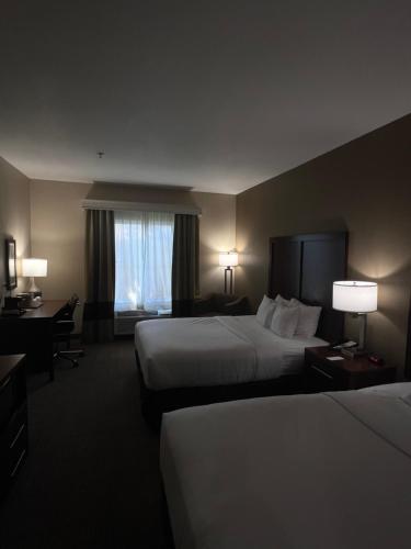 a hotel room with two beds and a window at Comfort Inn Marrero - New Orleans West in Marrero