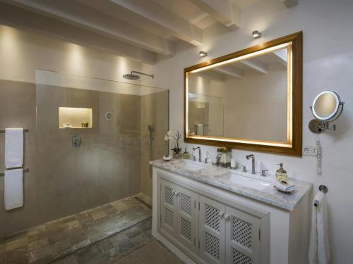 a bathroom with a sink and a mirror and a shower at Holiday home with spacious lounge area in Banyalbufar