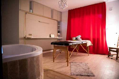 a room with a tub and a red curtain at LL Villa Sanandrei in Sânandrei