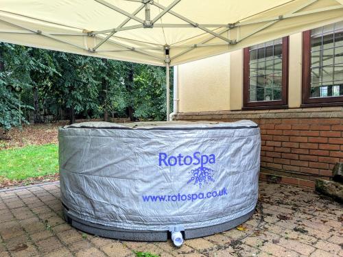 a large container with a cover on the side of a house at Spacious Home for Large Families and Contractors in Wolverhampton