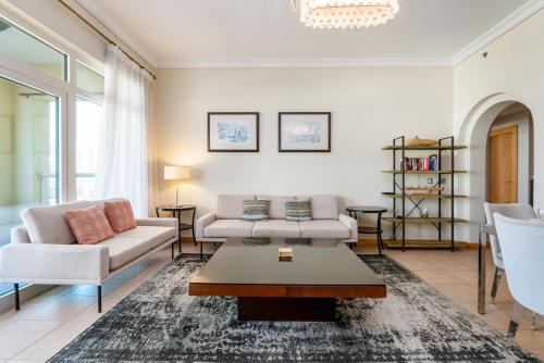 a living room with two couches and a coffee table at Bespoke Residences - 2 Bedroom Apartment Sea View with Beach Access in Dubai