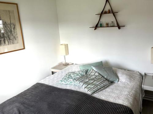 a bedroom with a bed with two pillows on it at 4 star holiday home in Åmål in Åmål