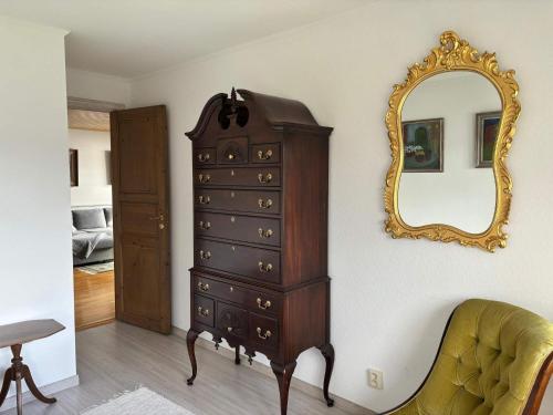 a dresser and a mirror in a room at 4 star holiday home in Åmål in Åmål