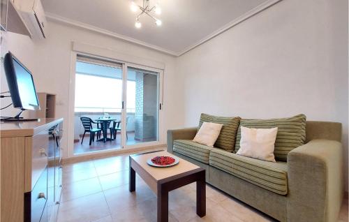 a living room with a couch and a table at Cozy Apartment In Oropesa Del Mar in Oropesa del Mar