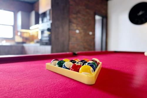 a tray of billiard balls on a red table at The Built-Up 2 BDR Condo 15 min to CAI Airpt in Cairo