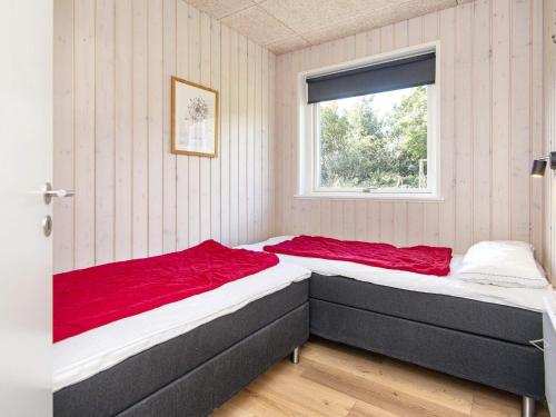 two beds in a room with a window at 4 star holiday home in Sydals-By Traum in Neder Lysabild