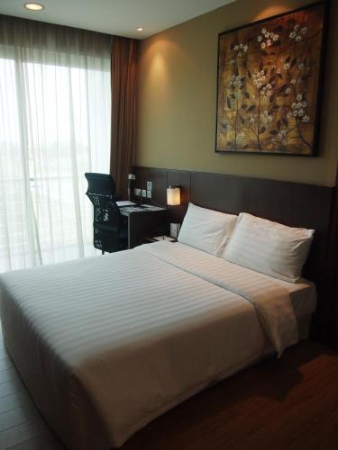 En eller flere senge i et værelse på Roomz Hotel