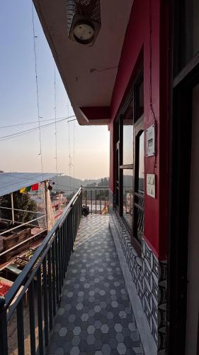 a balcony of a building with a view of the ocean at The Hostel Stories Dharamkot - Mcleodganj in McLeod Ganj