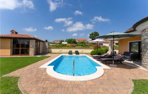 a swimming pool in a yard next to a house at Villa Morena in Buje