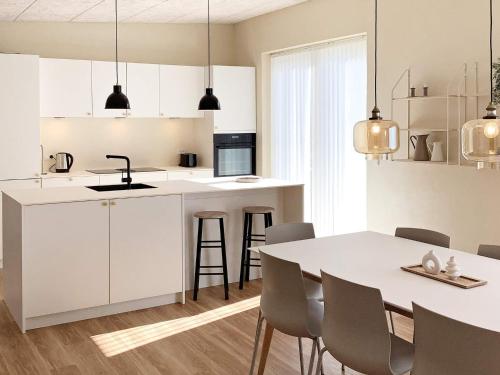 a kitchen and dining room with a table and chairs at 5 star holiday home in Vestervig-By Traum in Vestervig