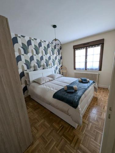 une chambre avec un grand lit et une grande fenêtre dans l'établissement Maison Chez Papy Chapeau 4 étoiles, à Leuvrigny