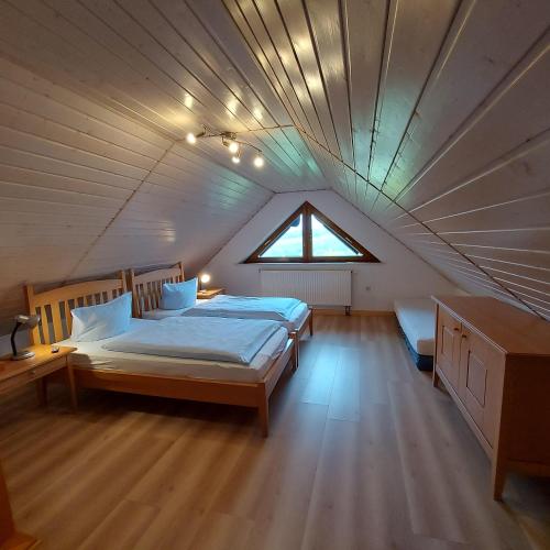 a bedroom with a large bed in a attic at Ferienwohnungen Lahmenhof in Poppenhausen