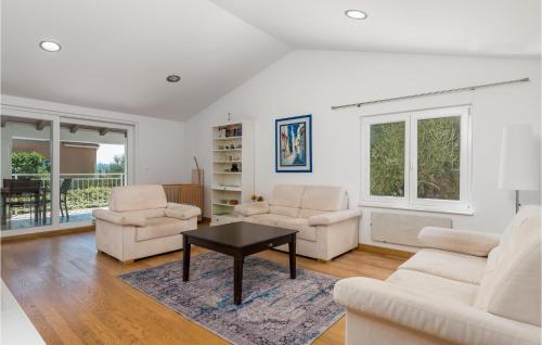 a living room with two chairs and a table at 3 Bedroom Cozy Home In Krk in Krk