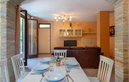 a dining room and living room with a table and chairs at Nice Home In Potenza Picena in Potenza Picena