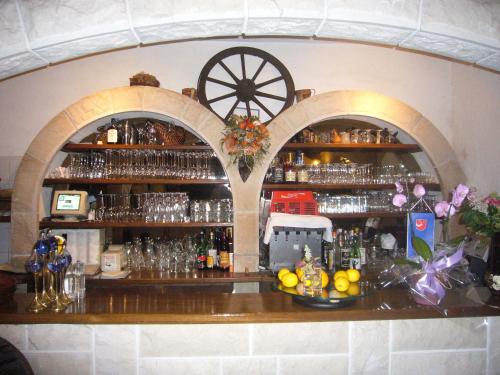 a bar in a room with two archways at Villa Rosa in Makarska
