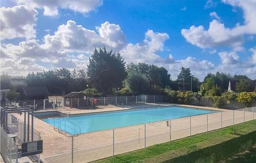 a large swimming pool with a fence around it at Beautiful Apartment In Bredene in Bredene