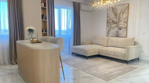 a living room with a couch and a chair at Vanilla Studio in Timişoara