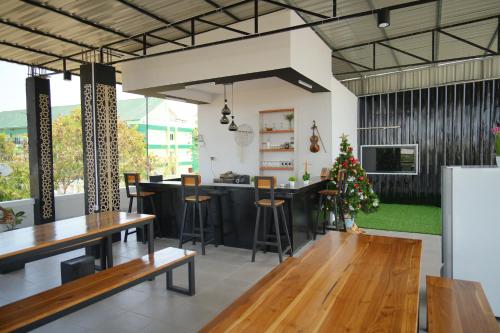 a restaurant with a bar and a christmas tree at Achazia Homestay in Labuan Bajo
