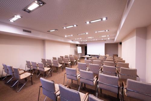 an empty room with chairs and a podium in it at Hotel Borowiecki in Łódź