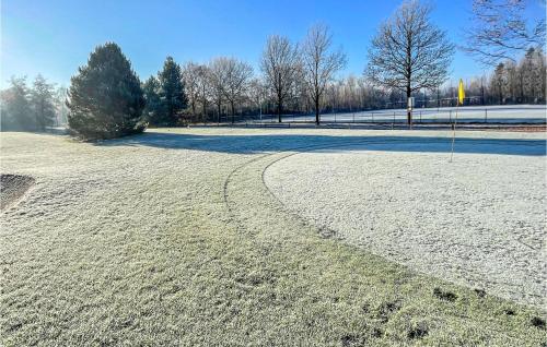 a snow covered field with a curve in the road at Cozy Home In Havelte With Wifi in Havelte