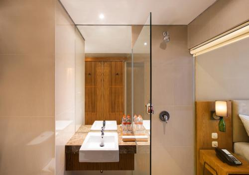 a bathroom with a sink and a shower at Yellow Star Ambarukmo Hotel in Yogyakarta