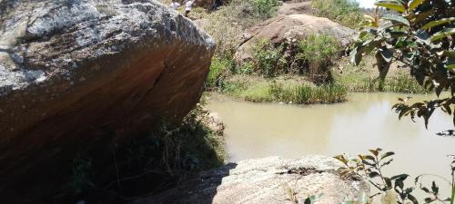 a large rock next to a body of water at Ecole Lodge Antananarivo in Mahitsy