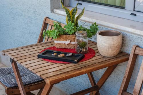 a wooden table with a tray and a plant on it at Main square apartment in Durrës
