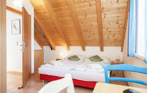 a bedroom with a bed and a wooden ceiling at Ferienhaus Rechnitz in Rechnitz